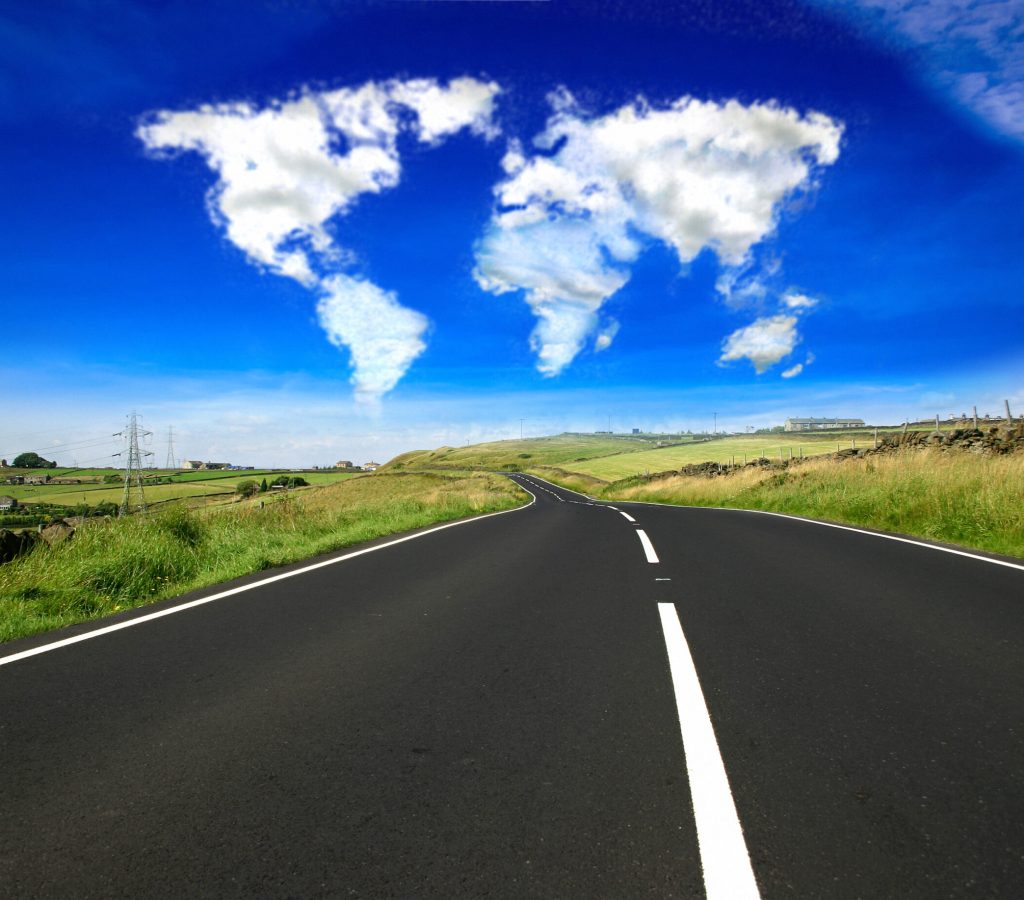 Clouds in the shape of the world over an open country road. This series: